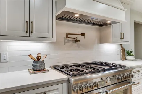 a stove top oven sitting inside of a kitchen