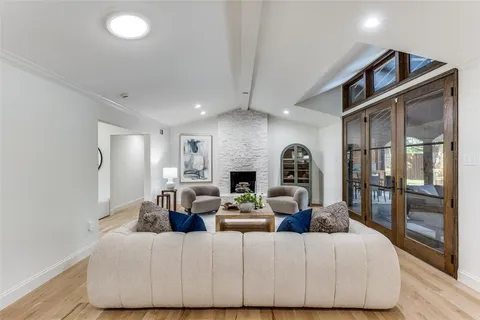 a living room with fireplace furniture and a floor to ceiling window