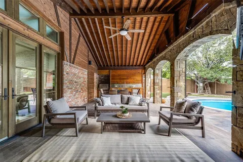 a living room with patio furniture and a floor to ceiling window