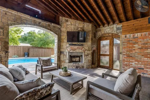 a living room with furniture a fireplace and a floor to ceiling window