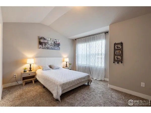 a bedroom with a bed and a night stand