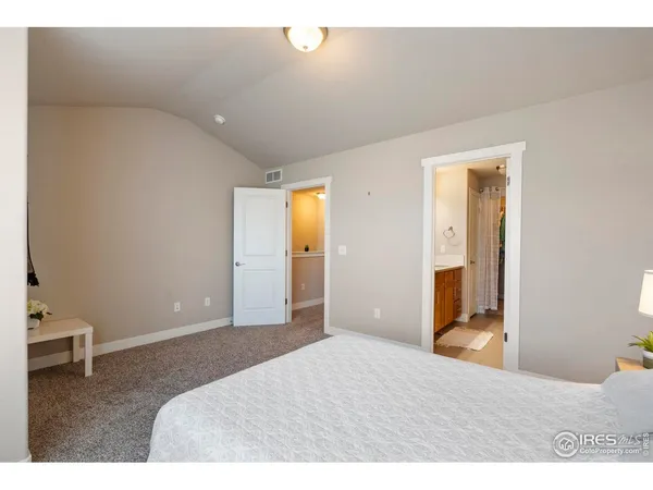 a bedroom with a bed and a lamp