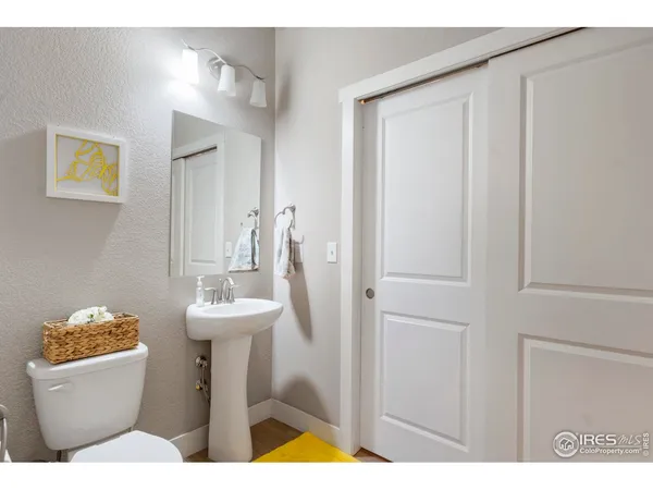 a bathroom with a sink a toilet and mirror