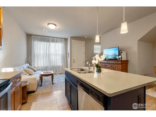 a kitchen with a sink cabinets and wooden floor