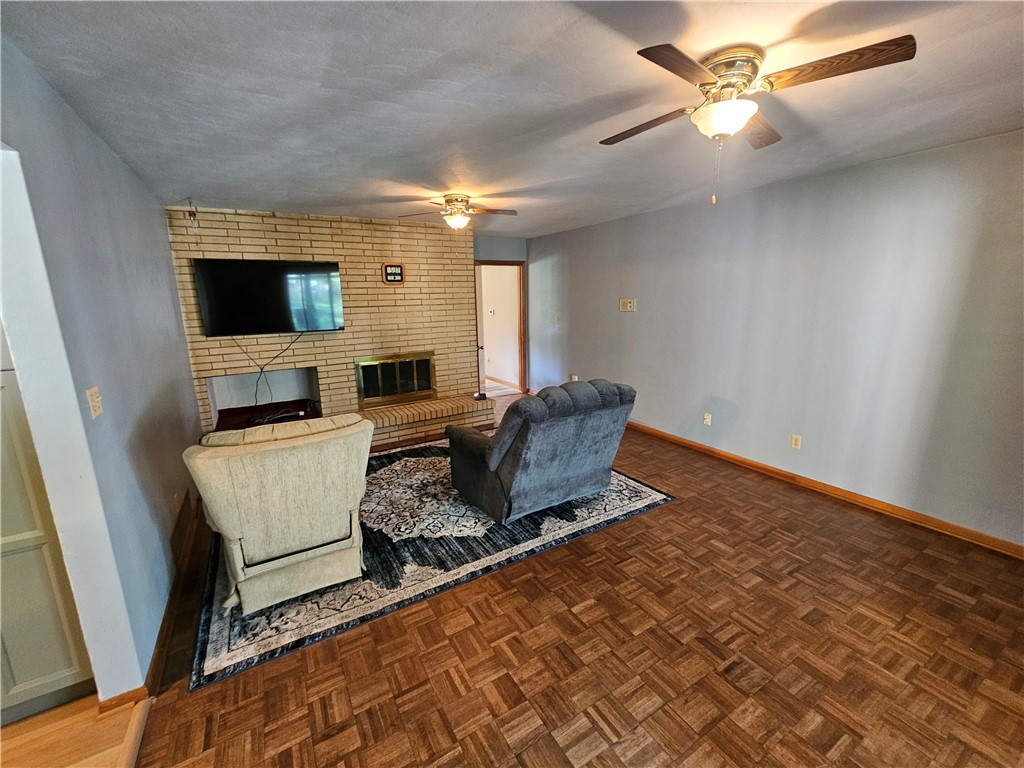 3998 Willowcrest Road Beavercreek, OH 45430 - Photo 31 of 41 This living room features a classic brick fireplace and elegant parquet flooring.