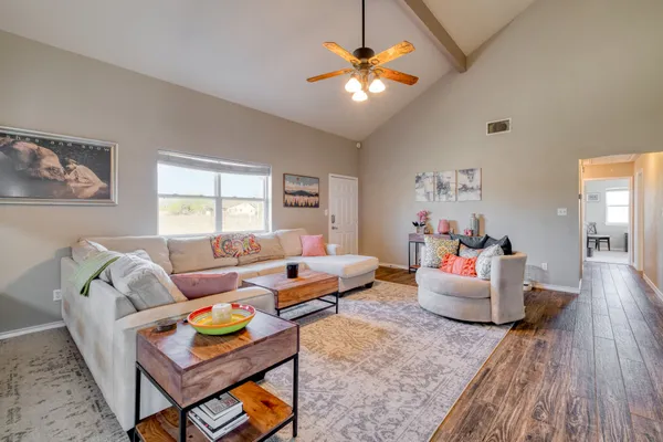 a living room with furniture and wooden floor