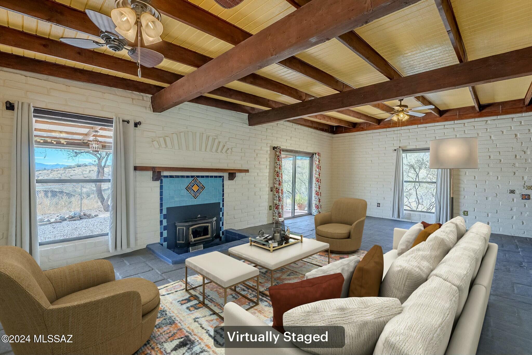 1312 Avenida Gutierrez Rio Rico, AZ 85648 - Photo 30 of 46 a living room with furniture a fireplace and a table