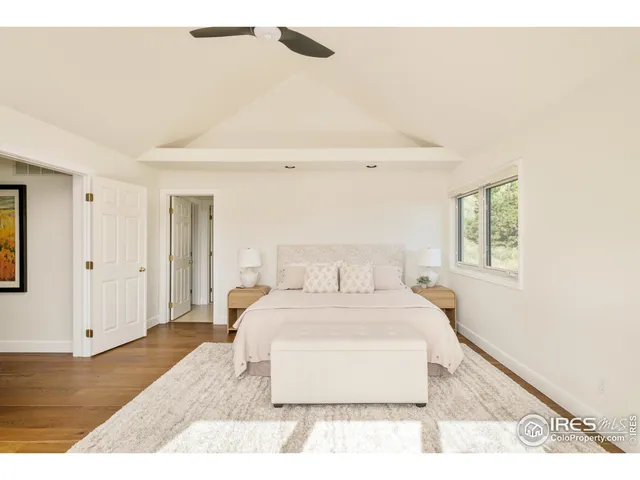 a bedroom with a bed and a night stand