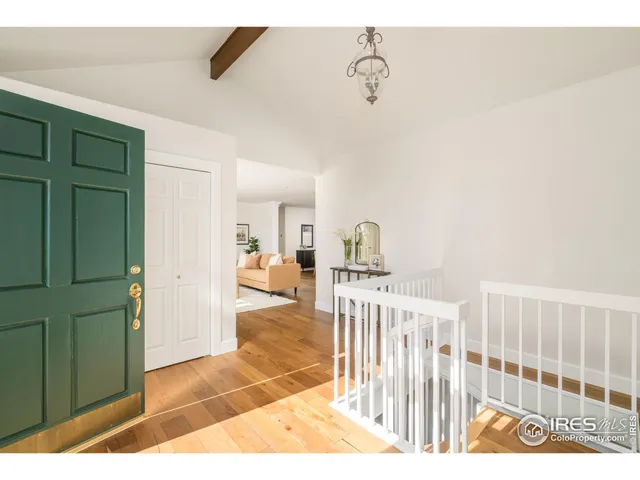 a view of a bedroom with wooden floor
