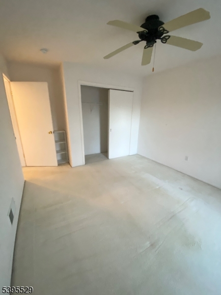 16 Mountain View Court Hamburg, NJ 07419 - Photo 11 of 21 en empty room with windows and a ceiling fan