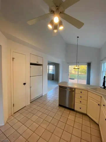 a kitchen with a refrigerator and a stove top oven
