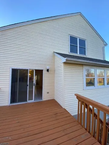 a view of a house with wooden deck