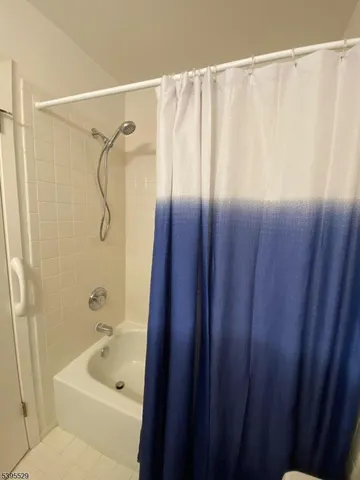 a bathroom with a shower and a tub
