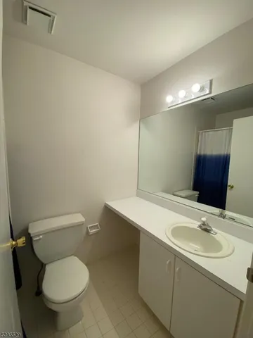 a bathroom with a sink toilet and mirror