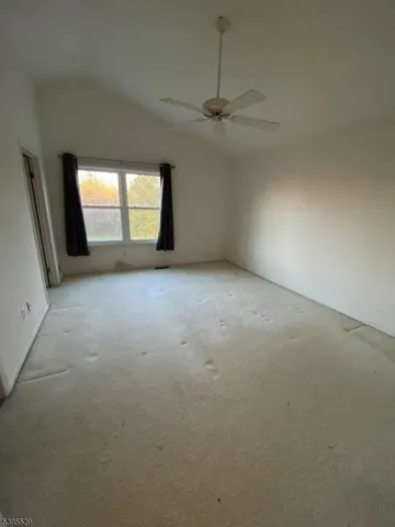 an empty room with a window and doors