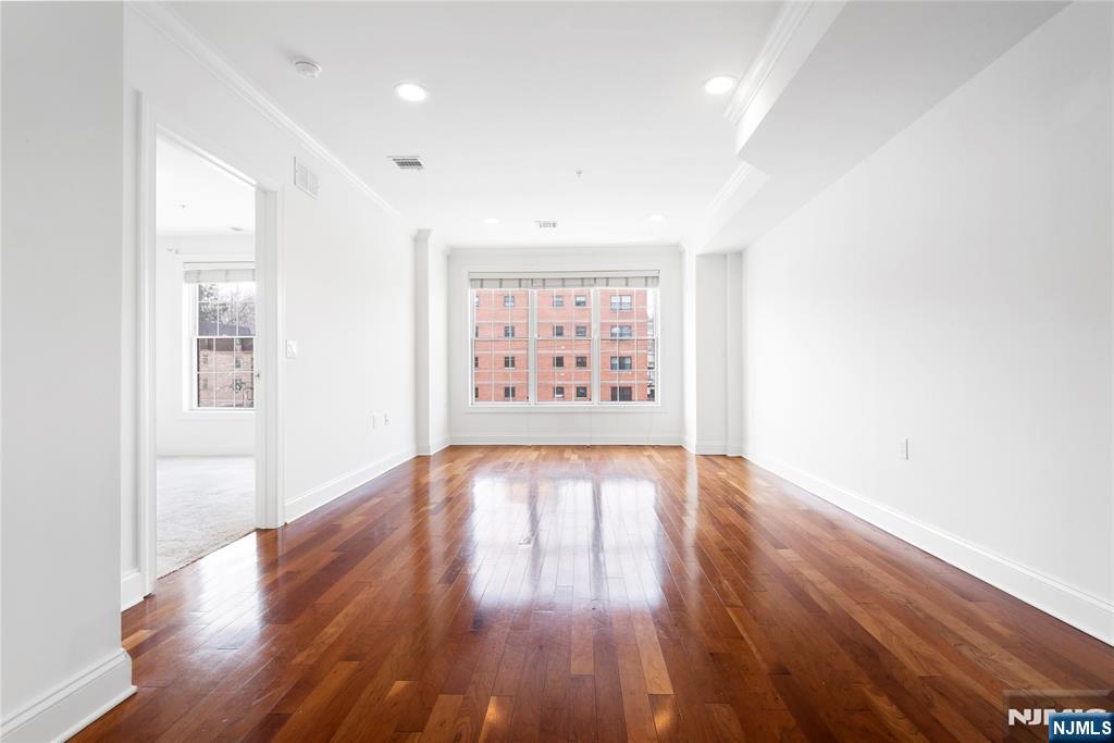 54 Polifly Road, Unit 311 Hackensack, NJ 07601 - Photo 4 of 20 wooden floor in an empty room with a window