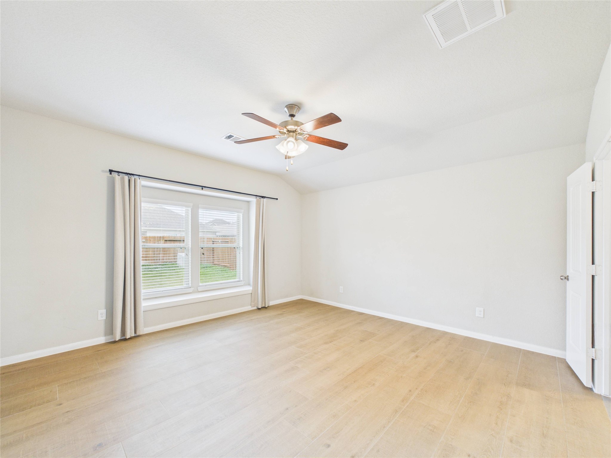 721 Rim Water Drive Alvin, TX 77511 - Photo 18 of 40 an empty room with fan and windows