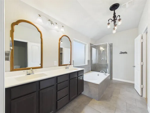 a bathroom with a double vanity sink a toilet and a mirror