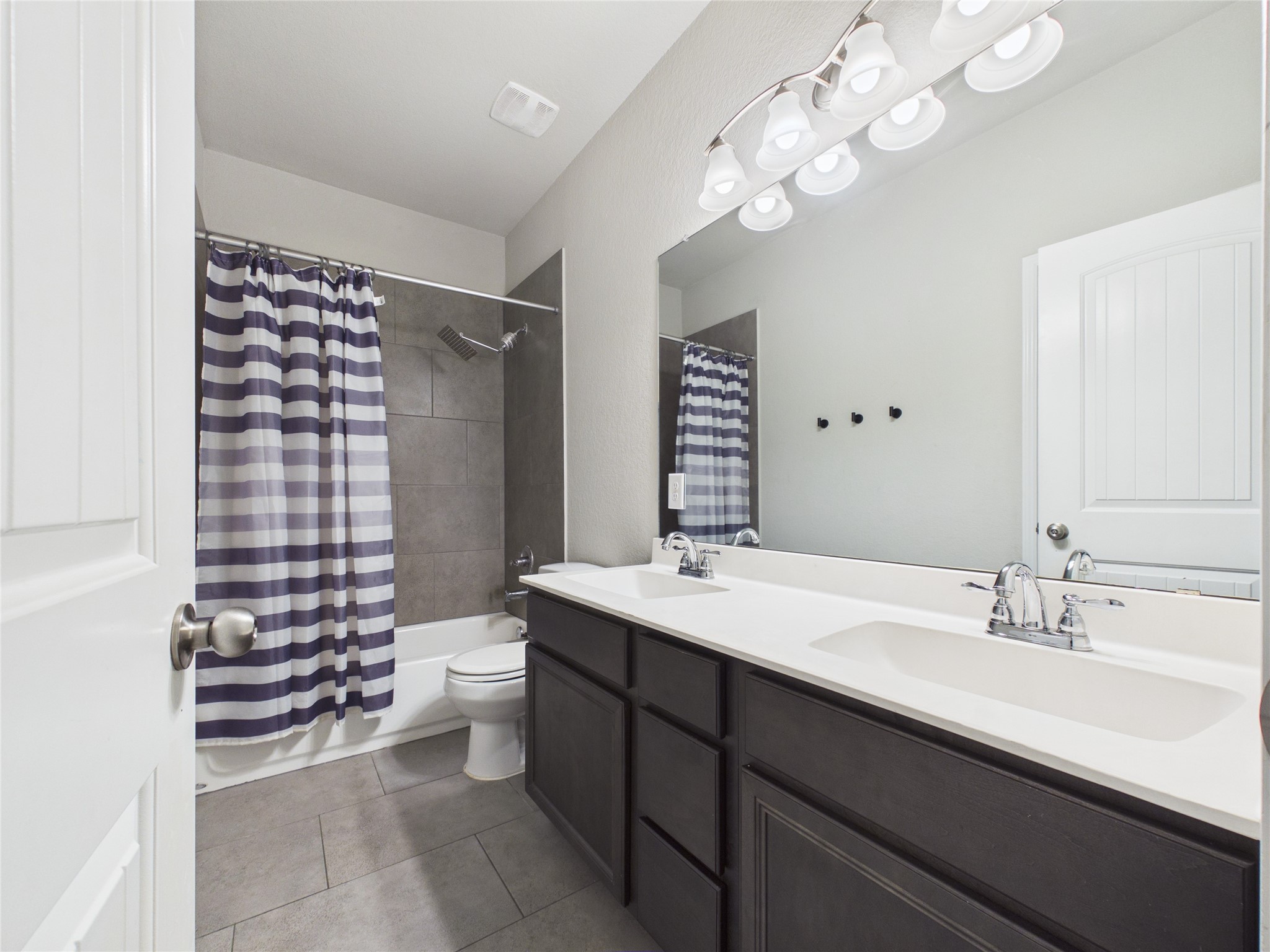 721 Rim Water Drive Alvin, TX 77511 - Photo 24 of 40 a bathroom with a double vanity sink mirror and toilet