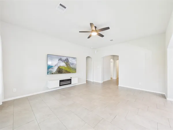 an empty room with projector and fan