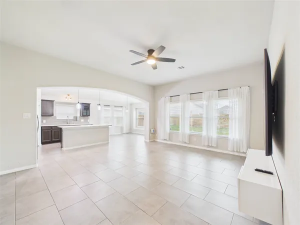 a view of an empty room with a kitchen