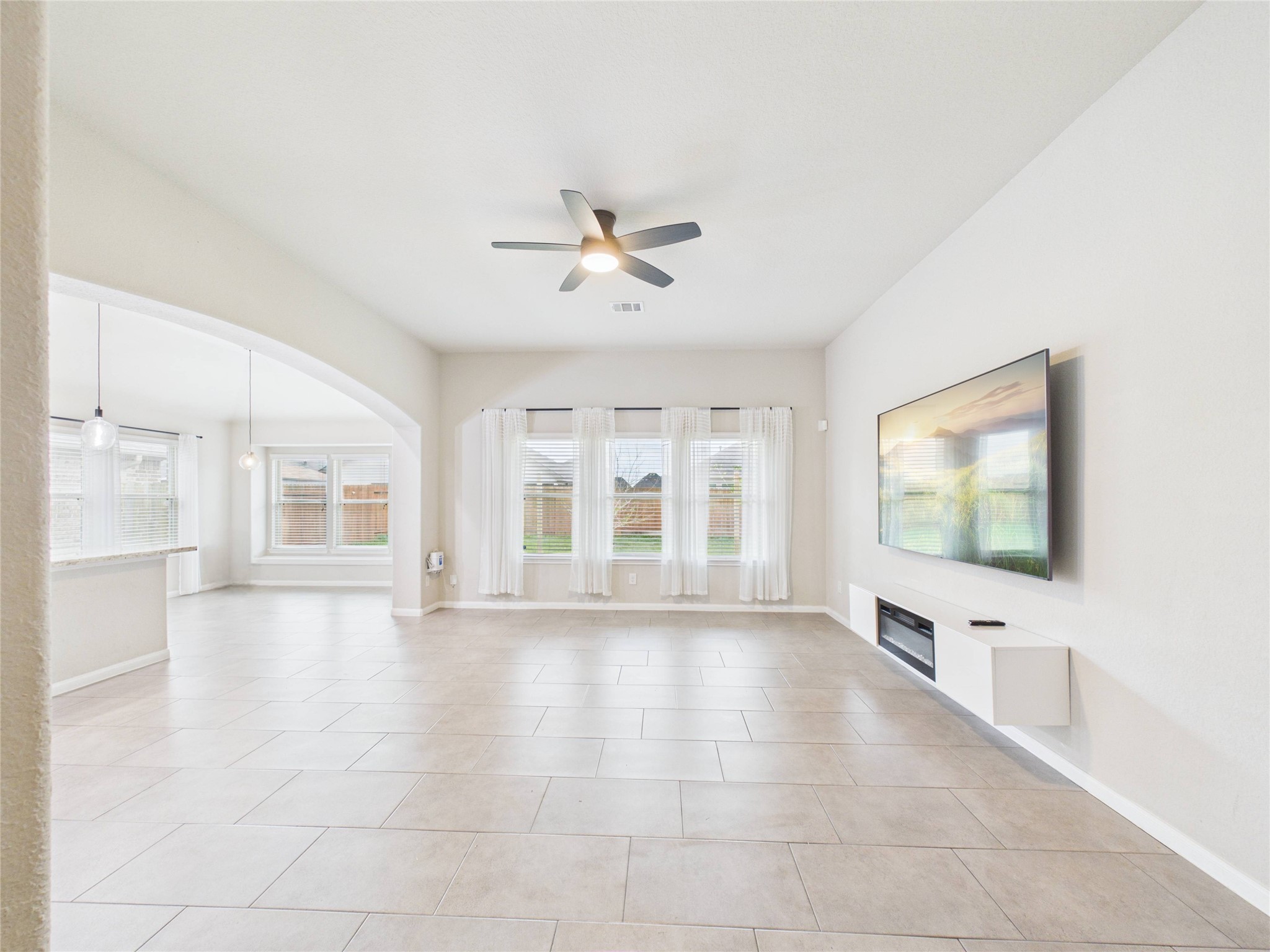 721 Rim Water Drive Alvin, TX 77511 - Photo 5 of 40 a view of an empty room with a window and a flat screen tv