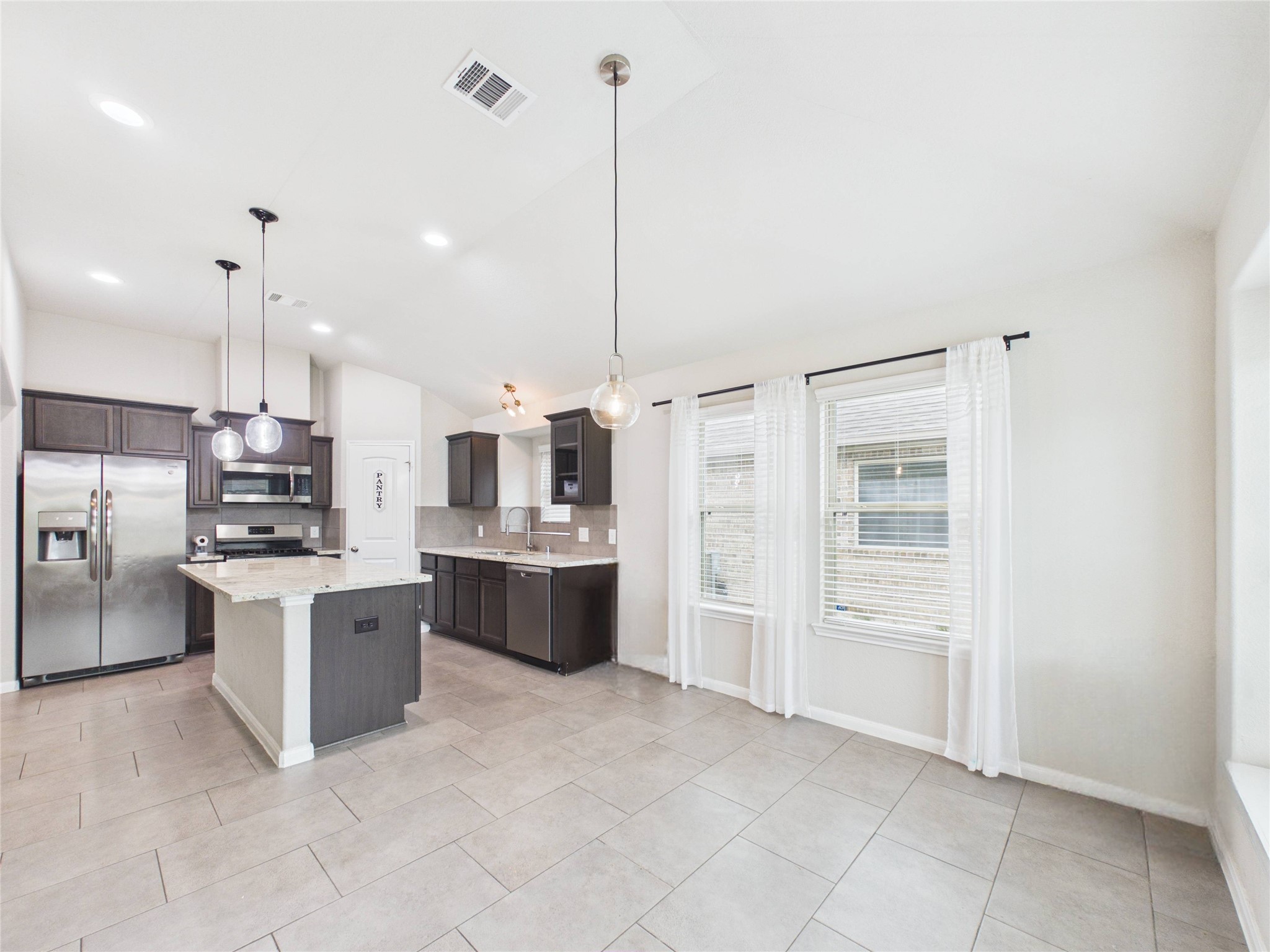 721 Rim Water Drive Alvin, TX 77511 - Photo 7 of 40 a large kitchen with cabinets