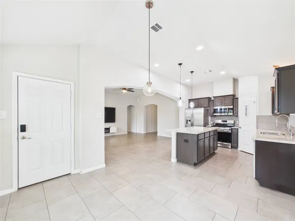 a large white kitchen with a large window