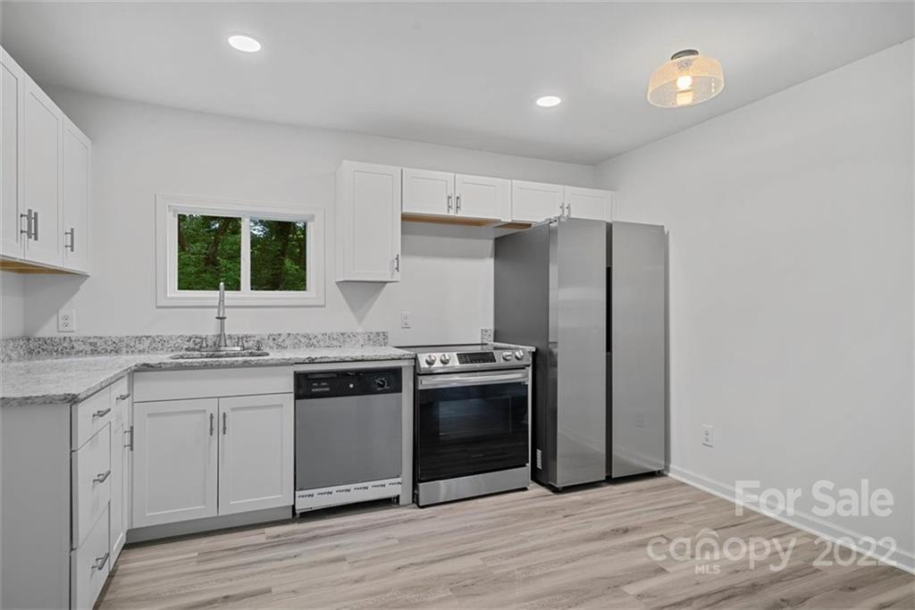 500 3rd Street Stanley, NC 28164 - Photo 11 of 19 a kitchen with stainless steel appliances granite countertop a refrigerator and a sink