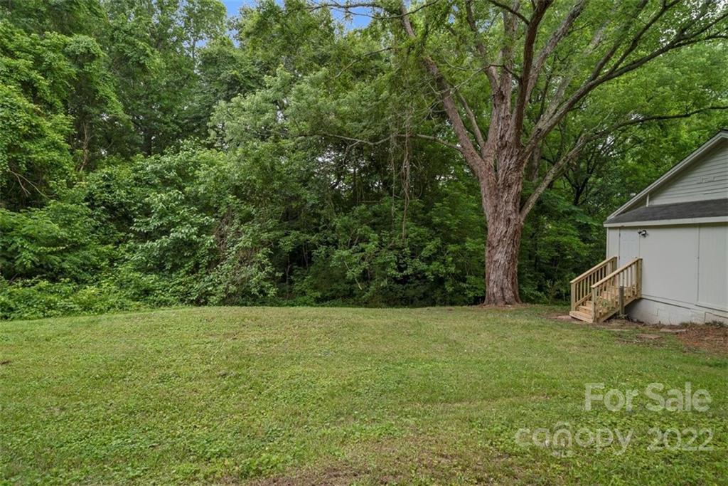 500 3rd Street Stanley, NC 28164 - Photo 18 of 19 a view of a backyard with a small cabin