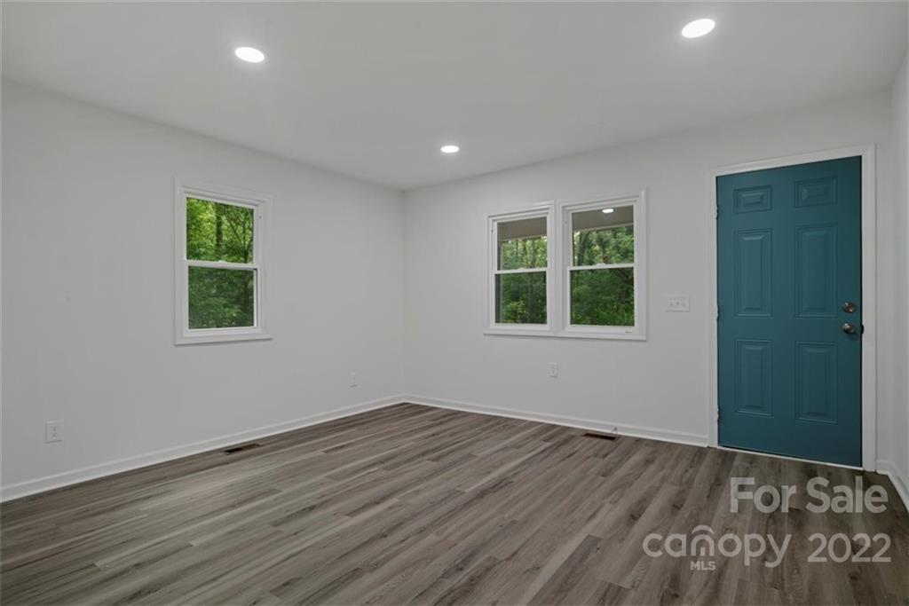 500 3rd Street Stanley, NC 28164 - Photo 4 of 19 an empty room with wooden floor and windows