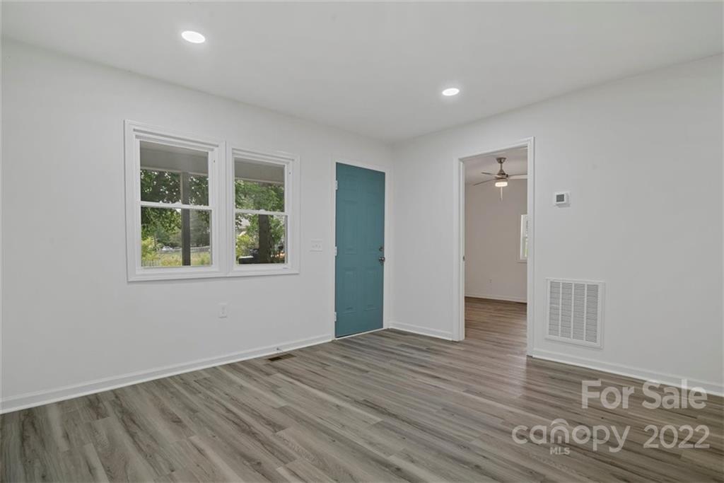 500 3rd Street Stanley, NC 28164 - Photo 5 of 19 a view of an empty room with wooden floor and a window