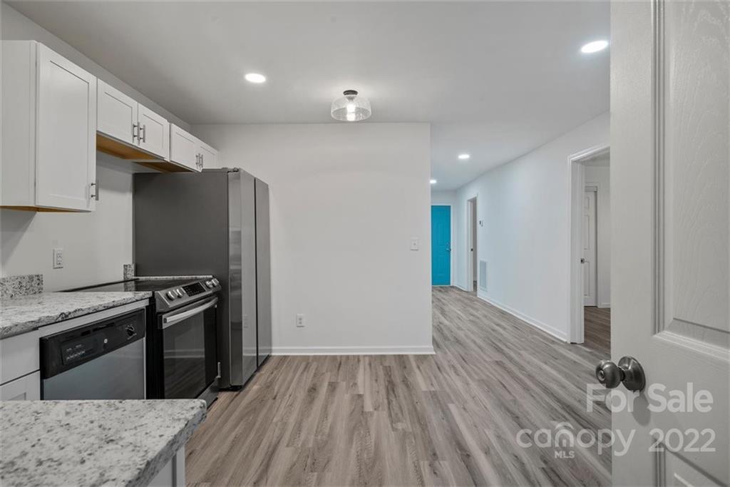500 3rd Street Stanley, NC 28164 - Photo 7 of 19 a kitchen with granite countertop a stove and a refrigerator