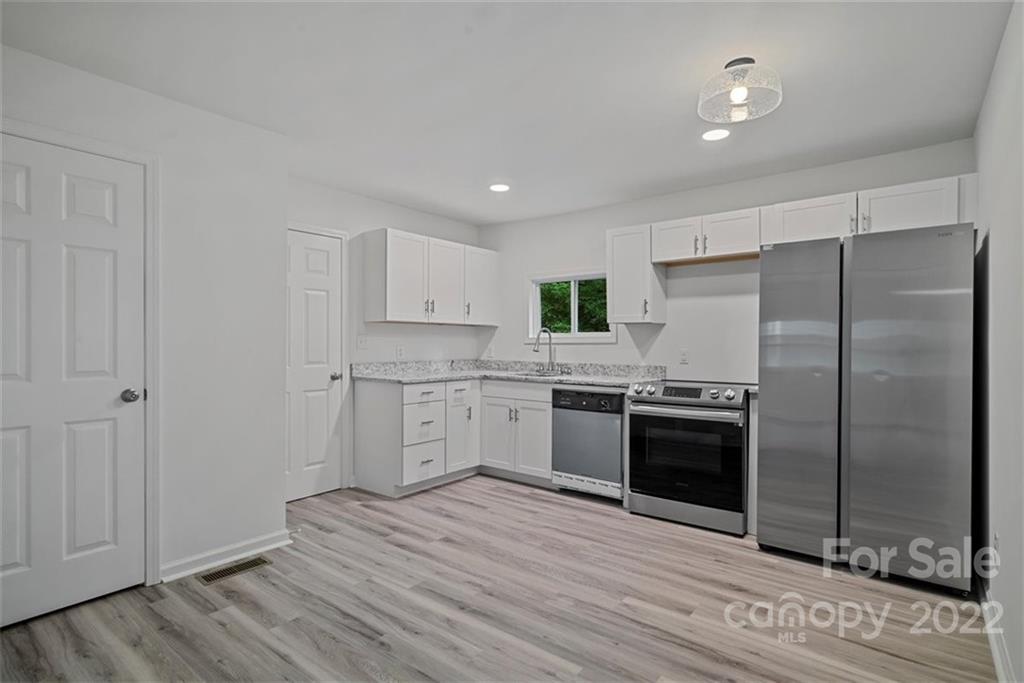 500 3rd Street Stanley, NC 28164 - Photo 8 of 19 a kitchen with stainless steel appliances granite countertop a refrigerator and a stove top oven
