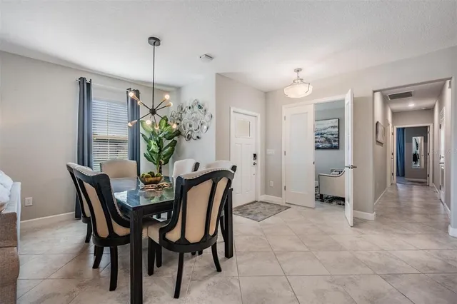 a view of a dining room with furniture and chandelier