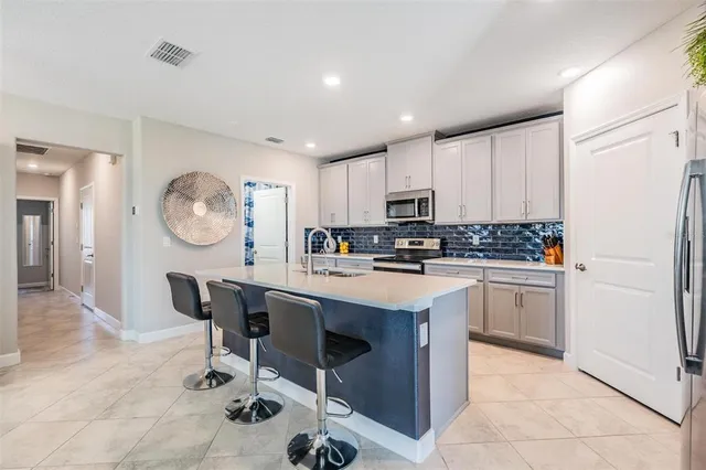 a kitchen with stainless steel appliances a sink stove and cabinets