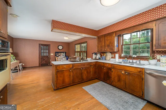 a kitchen with stainless steel appliances granite countertop a sink and cabinets