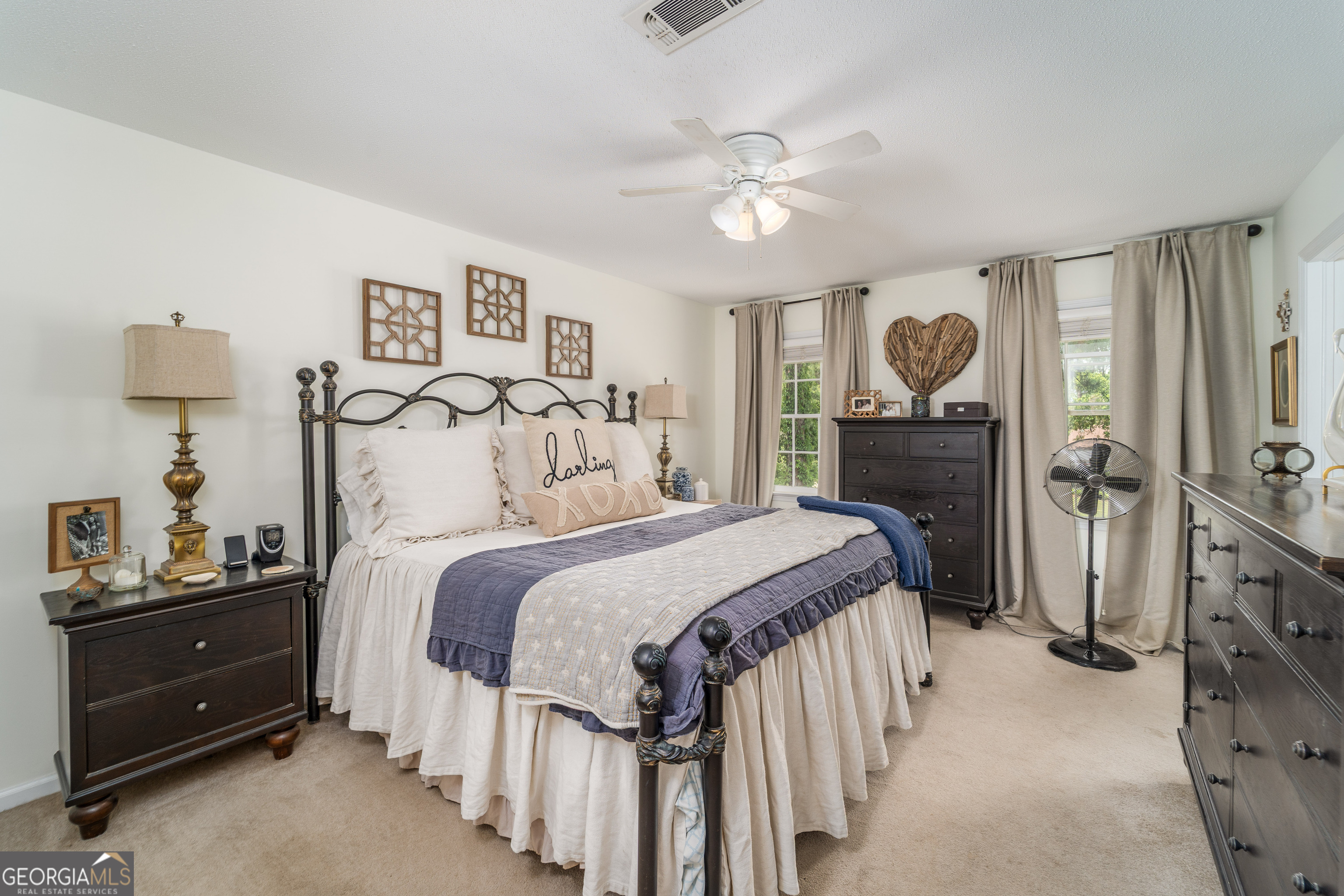 1312 Atlantic Avenue Waycross, GA 31501 - Photo 18 of 34 a bedroom with a bed and a chandelier