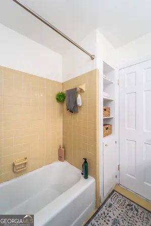 a bathroom with a bathtub and shower