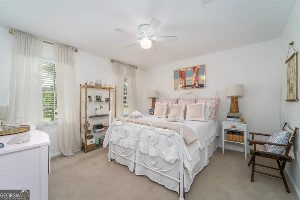 a spacious bedroom with a bed and a chandelier