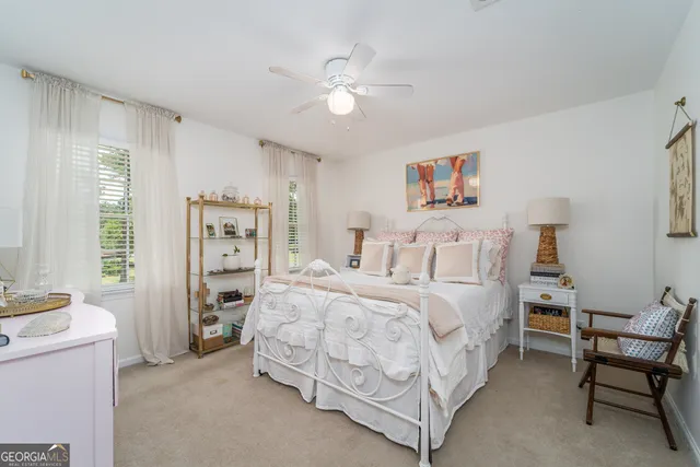 a spacious bedroom with a bed and a chandelier