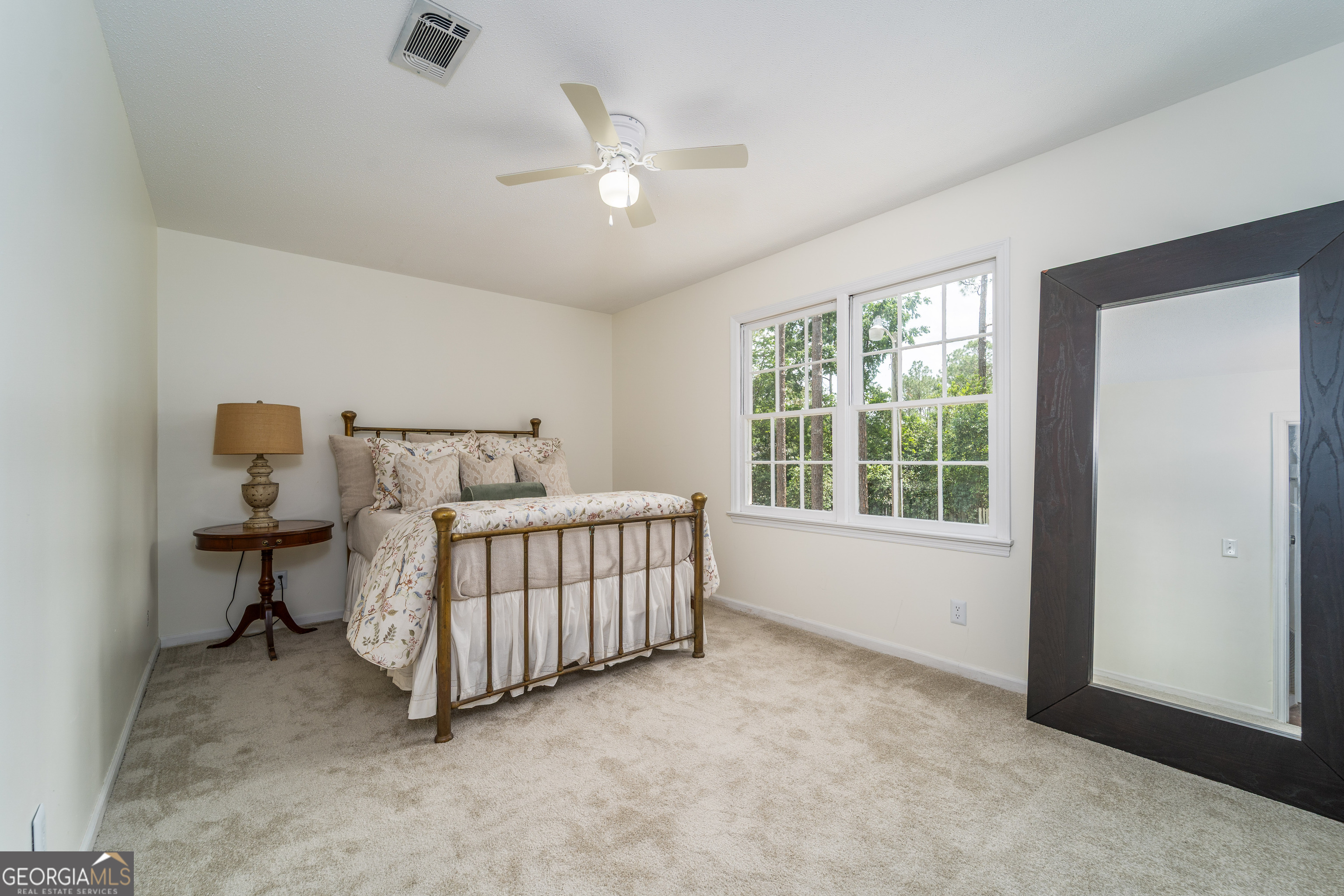 1312 Atlantic Avenue Waycross, GA 31501 - Photo 24 of 34 a bedroom with a bed and a window
