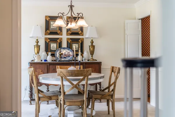 a view of a dining room with furniture and chandelier