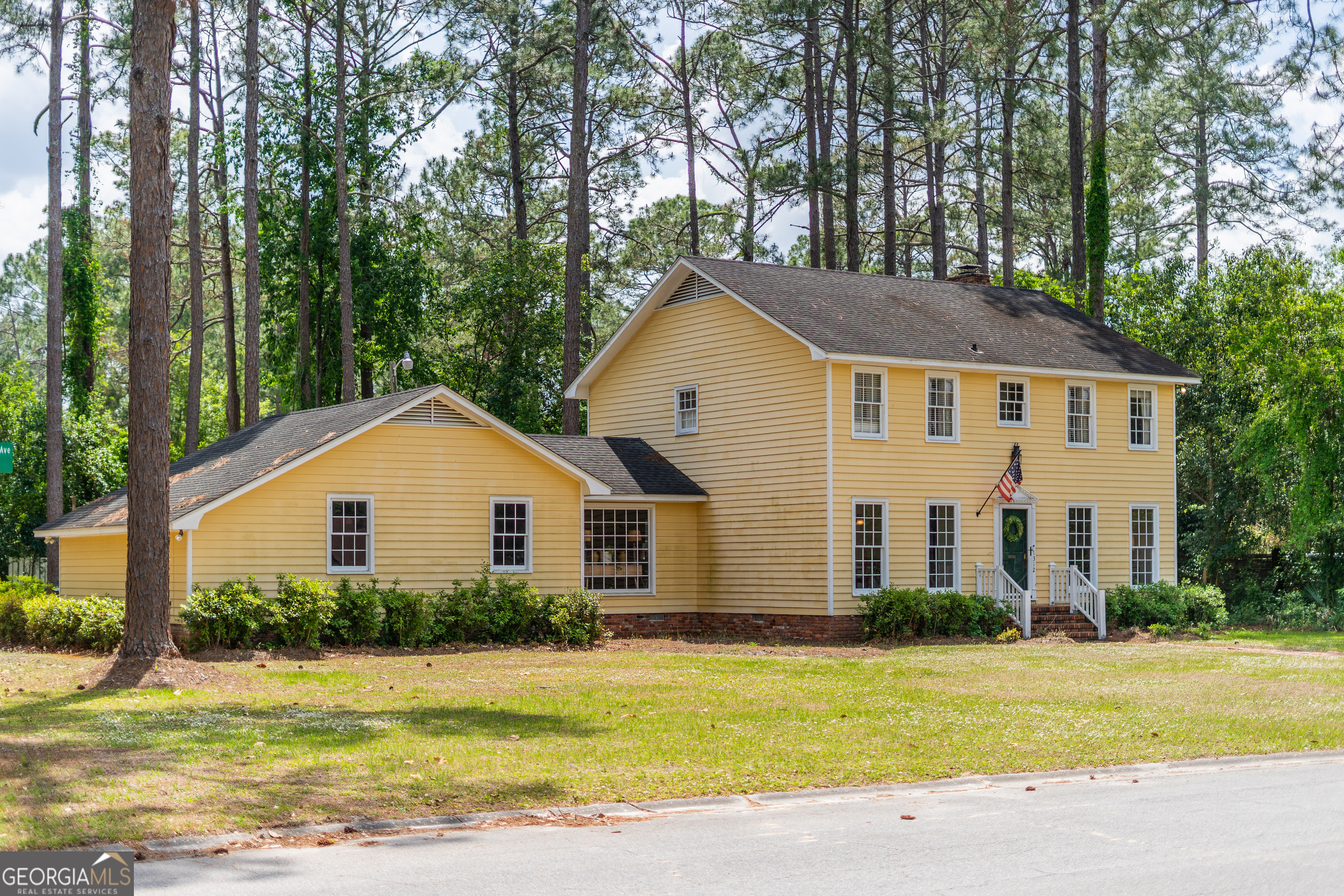1312 Atlantic Avenue Waycross, GA 31501 - Photo 34 of 34 a front view of a house with a garden and yard