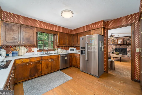 a kitchen with refrigerator a sink and cabinets