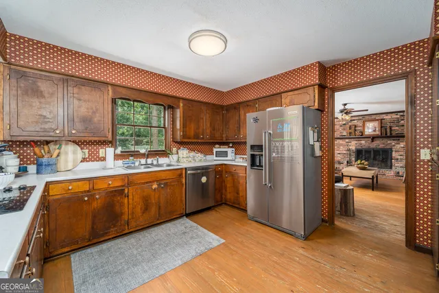 a kitchen with refrigerator a sink and cabinets