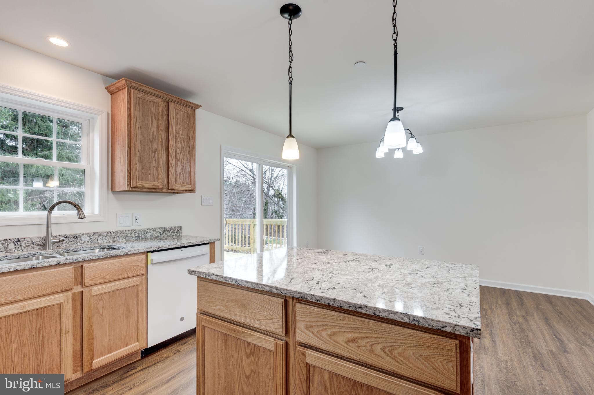 3406 Viewridge Circle Manchester, MD 21102 - Photo 13 of 57 a kitchen with kitchen island granite countertop cabinets and window