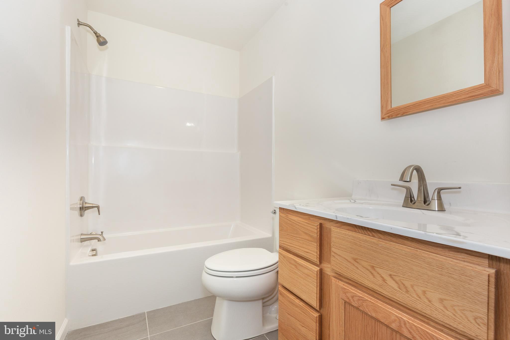 3406 Viewridge Circle Manchester, MD 21102 - Photo 15 of 57 a bathroom with a toilet a sink a mirror and bathtub