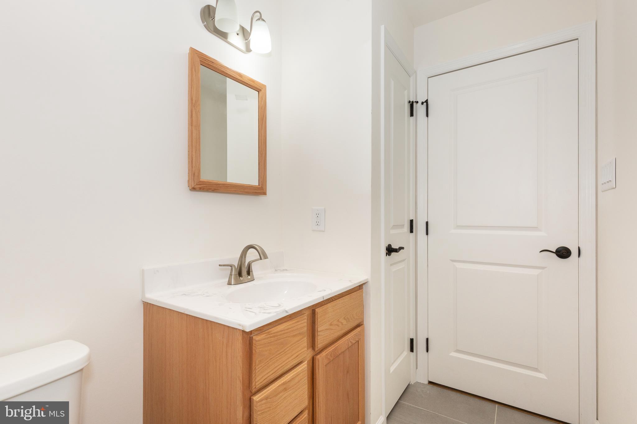 3406 Viewridge Circle Manchester, MD 21102 - Photo 16 of 57 a bathroom with a sink a mirror and a toilet