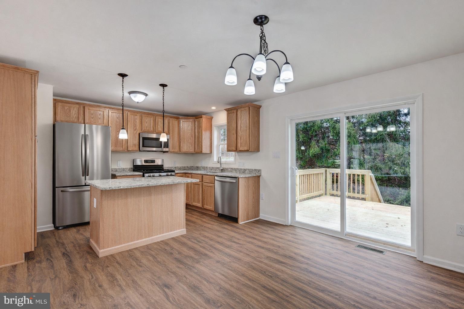 3406 Viewridge Circle Manchester, MD 21102 - Photo 2 of 57 a open kitchen with stainless steel appliances granite countertop a refrigerator a stove oven a sink dishwasher and white cabinets with wooden floor